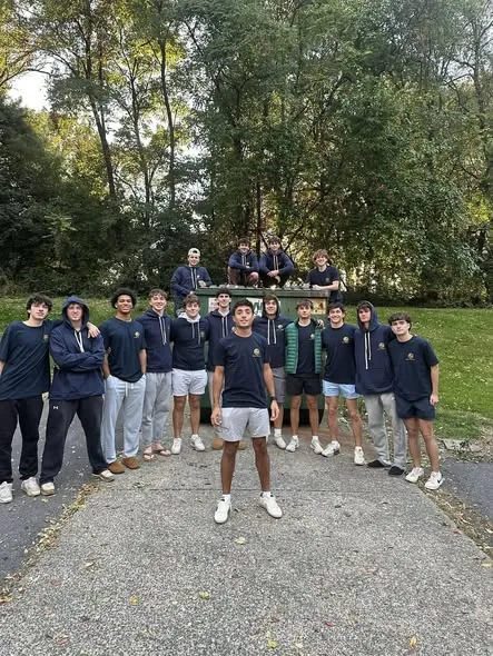 The full Gen Z Junk Removal student crew gathered around the dump trailer